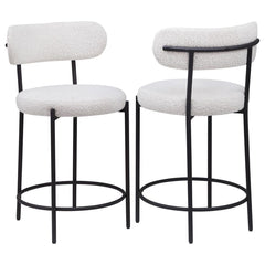 Your kitchen island or counter table gets an instant upgrade with this set of two modern barstools. The pair features contemporary boucle upholstery in a neutral hue over foam cushions for comfort. Metal framing features a black finish and provides excell