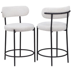 Your kitchen island or counter table gets an instant upgrade with this set of two modern barstools. The pair features contemporary boucle upholstery in a neutral hue over foam cushions for comfort. Metal framing features a black finish and provides excell