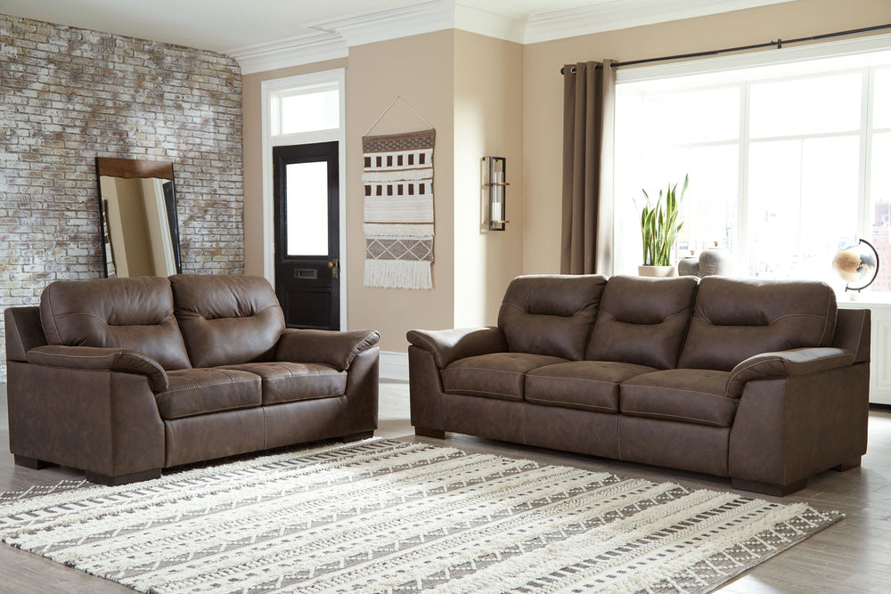 Everyone can have the best seat in the house with this sofa and loveseat. An indulgent choice with deep seats crafted for cloud-like softness, this set is the ideal merger of modern flair and classic staying power. <h4><b>Maderla - Walnut - Sofa</b></h4> 