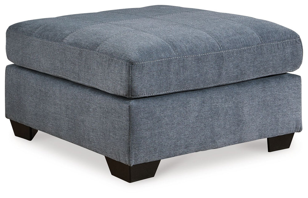 This oversized accent ottoman takes a homey approach to high style. Its denim-inspired fabric has classic versatility, while a contemporary silhouette and stitched details keep the look totally on trend. And you can count on comfortâ€”the ottoman-'s large