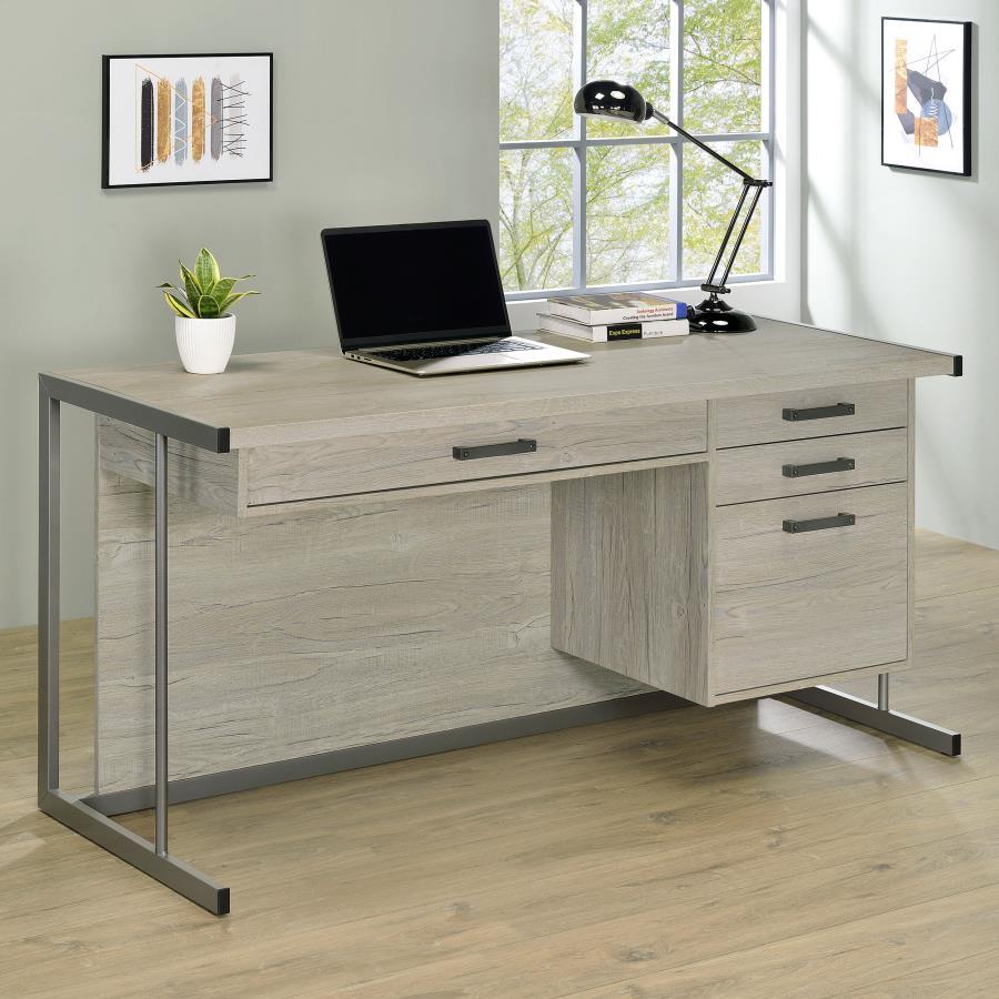 Elevate your contemporary home office and organize your supplies with this spacious contemporary office desk, featuring a light and bright whitewashed grey finish that maintains a clean look and feel to the space. Four drawers, including a deep file drawe