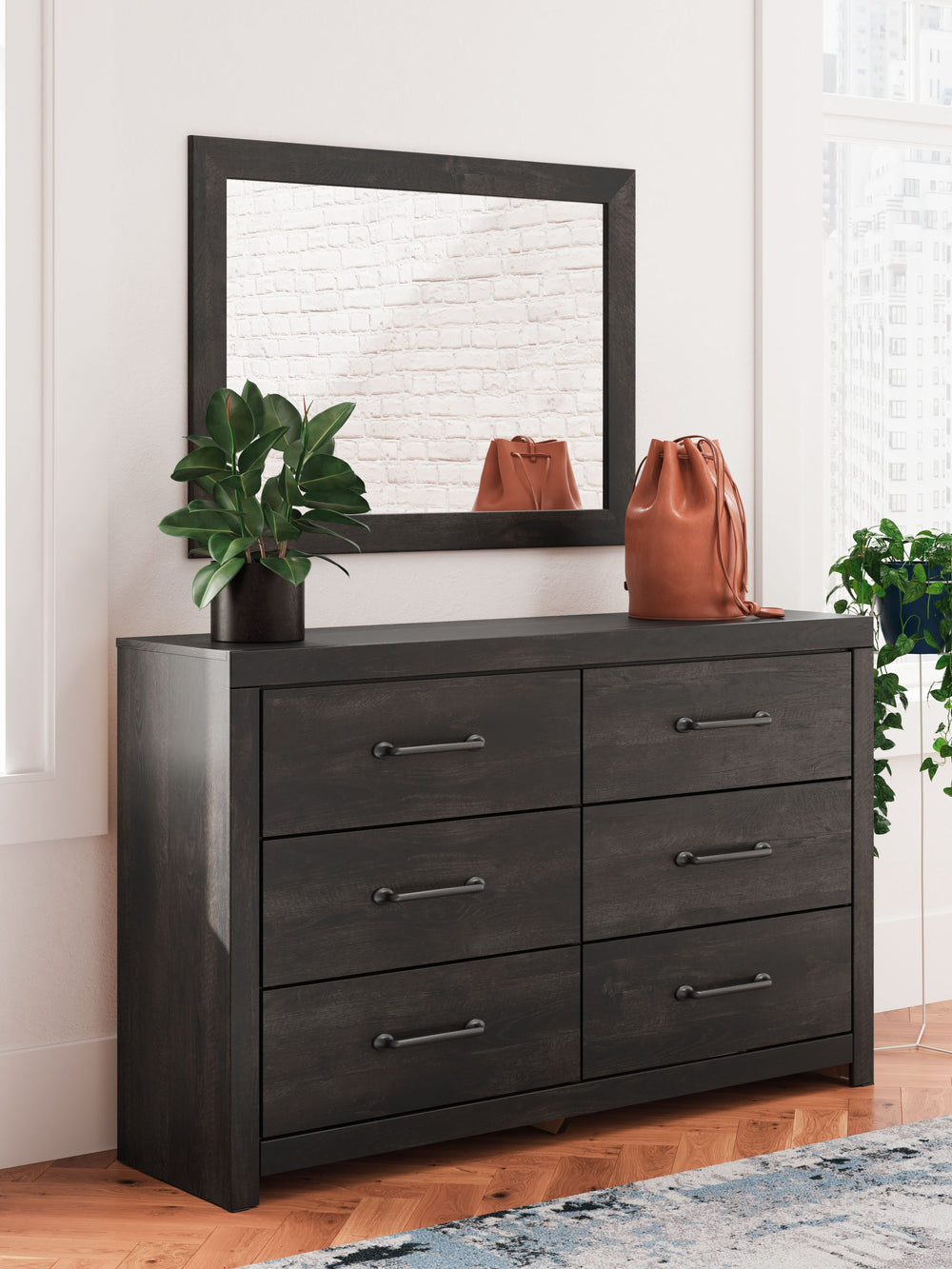This dresser with mirror puts a casually chic twist on everyday function. Its rustic charcoal finish pairs well with other neutrals and pops of color alike, giving you the flexibility to change up your aesthetic as you please. Smooth-gliding drawers keep 
