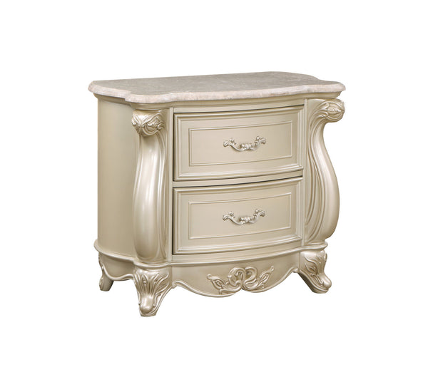 The Monique Marble Top 2 Drawer Nightstand in Champagne combines heirloom quality construction with French Provincial elegance. Crafted with poplar solids and birch veneers, this nightstand ensures strength and durability. Reflecting the charm and sophist