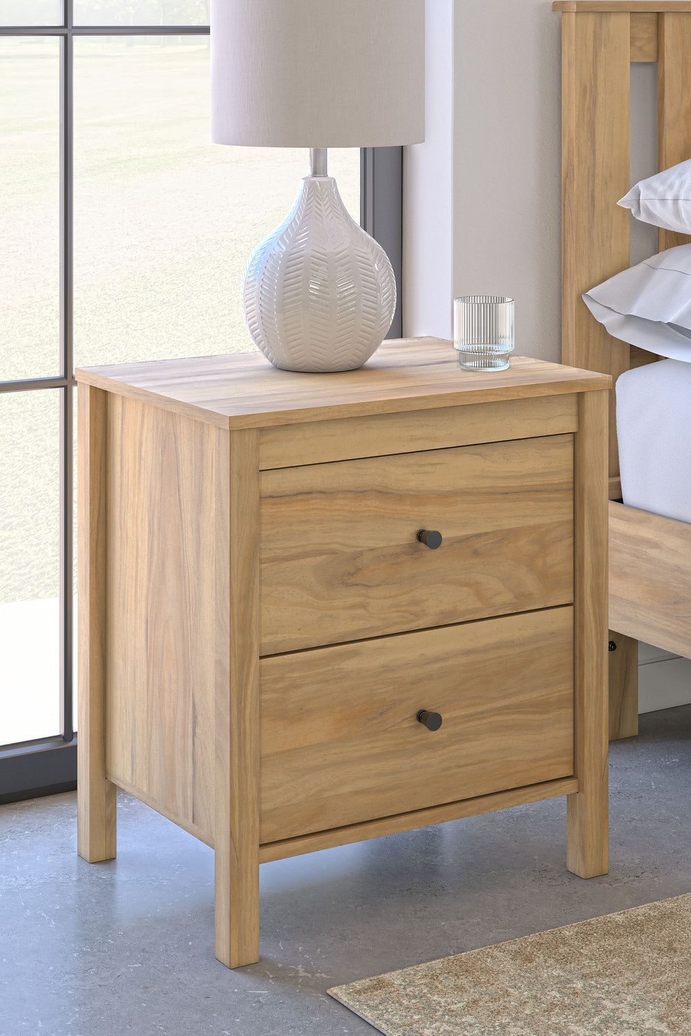 This nightstand puts the dream of a casual bedroom retreat beautifully within reach. A warm light brown finish over replicated hickory grain exudes a homey vibe. The smooth-gliding drawers are exceptionally handy for bedside storage. Itâ€™s a simply relax