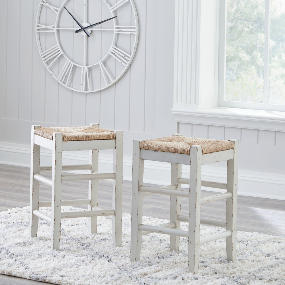 Bring the vintage casual vibe you love to the kitchen with this counter height bar stool. A stylish seating solution in a white rubbed-through finish, this charming stool completes your dining space with ease. The woven seagrass seat and wood stretchers c