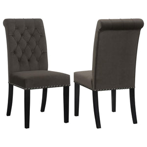 Blending timeless elegance with plush comfort, this side chair enhances any dining space. Its high backrest features a classic button-tufted design, adding depth and sophistication. A rolled top and hand-applied nailhead trim create refined detailing, whi