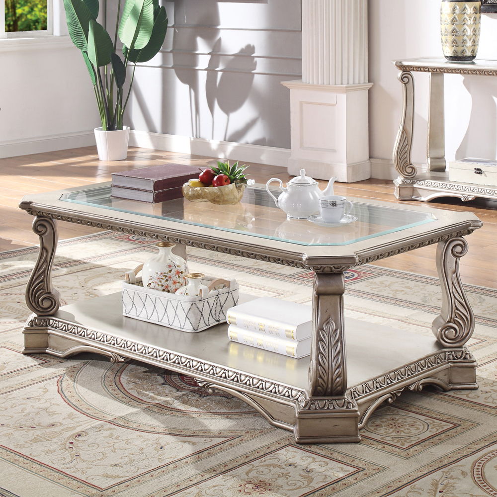 Entertain in style with the Northville Coffee Table. This classic rectangular occasional table features an Antique Silver and a tempered glass top. This distinctive cocktail is accented with wooden floral scrolled legs and a beveled glass insert and an op