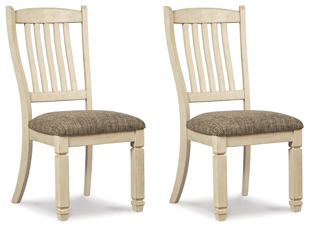 The beauty of this upholstered dining chair is something to savor. Designed to serve up comfort and flair, this rake-back dining chair entices with a cushioned seat covered in a heavy woven fabric that complements the chairâ€™s antiqued white finish.<br><