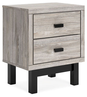 Craft a contemporary hideaway without breaking the bank. An elegant juxtaposition of refined neutral hues, this two-toned nightstand brings sleek style to your space. Matte black drawer handles enhance the sheer simplicity of its profile. With this bedsid