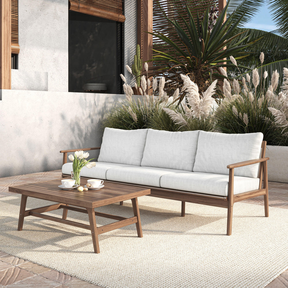 The Ashton 2-Piece Patio Set, featuring a stylish outdoor sofa with natural cushions and a matching coffee table, seamlessly blends durability, comfort, and timeless design to create the ultimate outdoor retreat. Expertly crafted from FSC-Certified Acacia