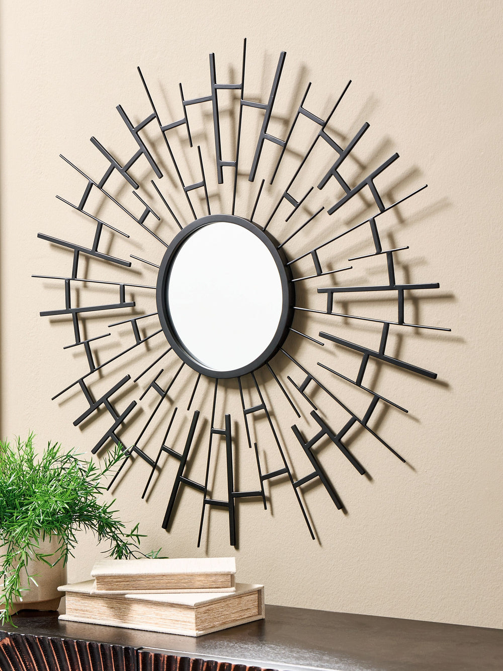 This accent mirror makes a bold statement in contemporary and industrial spaces. Framed with sunburst-style metal fretwork and finished in a luxe black, it-'s a fabulous blend of form and function.<br><br><b>Additional Dimensions</b><br><ul><li>Inner mirr