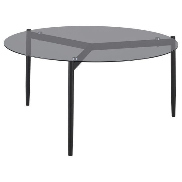 This modern coffee table features a sleek, tempered smoked glass top that adds sophistication to any space. Its sturdy metal base, finished in a black powder-coated sandy texture, provides stability and a contemporary edge. The round design creates a welc