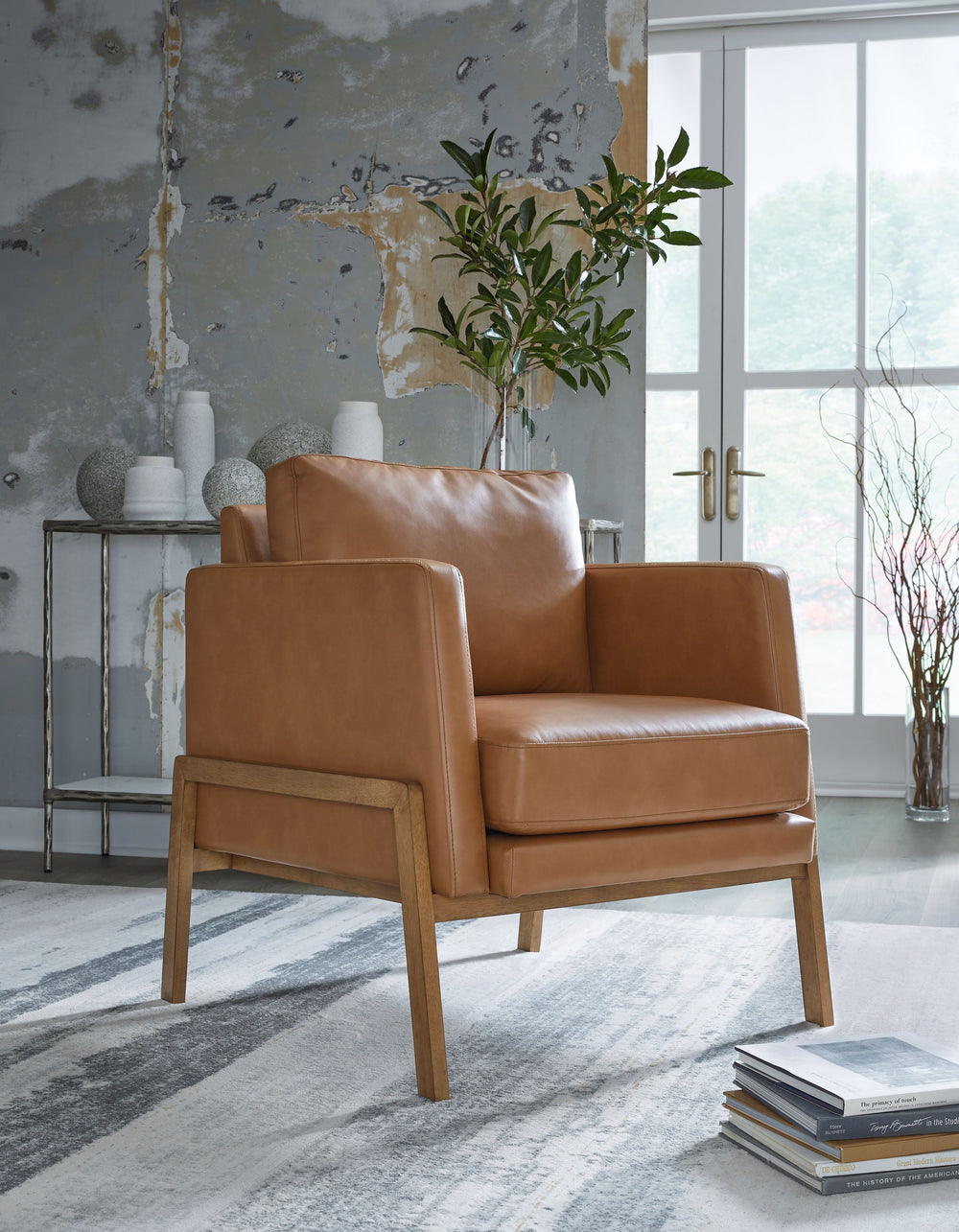 This accent chair is effortlessly elevated with its sleek, clean lines. Caramel faux leather gives your space a luxe vibe while keeping the price within reach. The chair-'s simple take on contemporary aesthetics gives you versatility while stagingâ€”set i