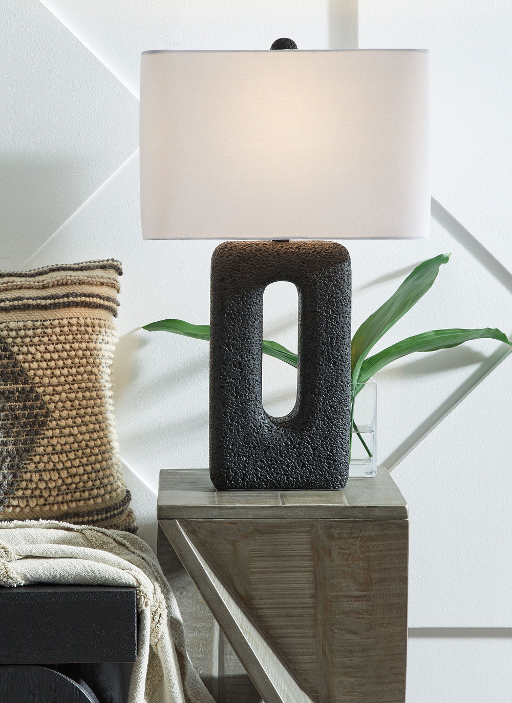 These sculptural table lamps are an enlightening choice for those with an eye for clean-lined, modern design. The textured cutout base and sleek rectangular shade elevate them to an art form. Place these accent lamps on a console table for a touch of chic
