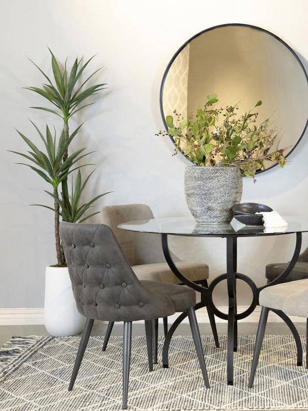  this dining side chair is a stylish and versatile addition to any dining space. The gently curved backrest features elegant button tufting on the exterior and a smooth