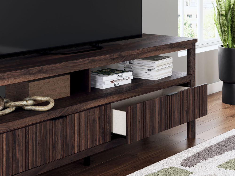 Crafted with both form and function in mind, this TV stand brings a dash of retro-cool character to your modern boho aesthetic. A reeded design on its drawers adds an on-trend touch to storing entertainment essentials. Warmly welcoming with a rich brown f