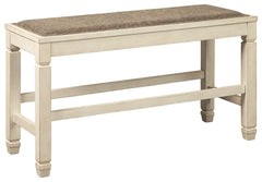 The beauty of this upholstered dining bench is something to savor. Serving up comfort and flair, this generously scaled counter-height bench entices with a cushioned seat covered in a heavy woven fabric that complements the antiqued white finish.<br><br><