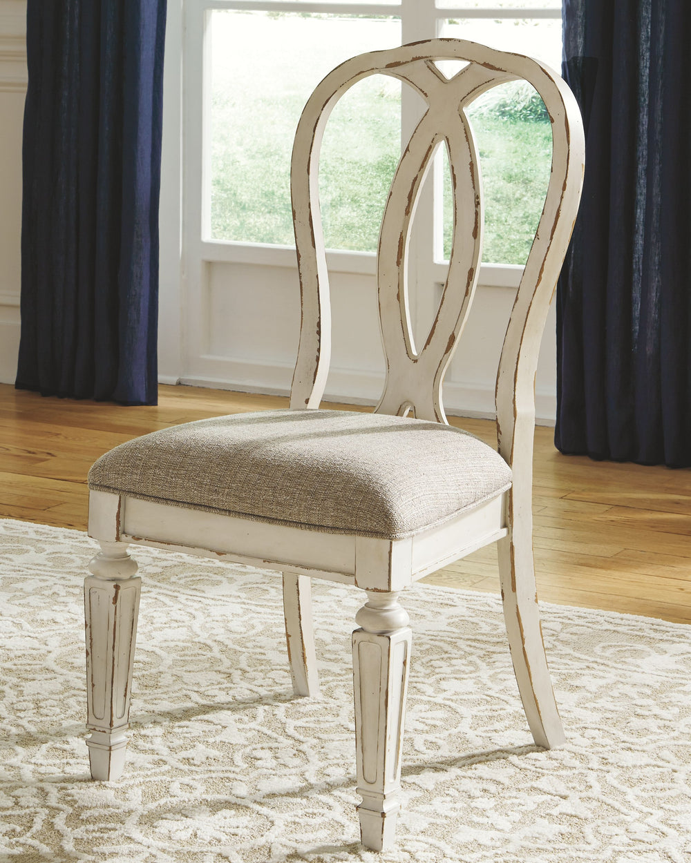 French twist. With its stylized ribbon back, chipped white finish and plushly cushioned seat, this dining room chair has all the right ingredients for a French country-inspired feast for the eyes.<br><br><b>Additional Dimensions</b><br><ul><li>Seat width: