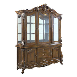  the Latisha dining table is the perfect merging of contemporary and classic. The antique oak finish with the hand-brushed silver trim accentuates the elaborate floral moldings that are showcased throughout the legs 