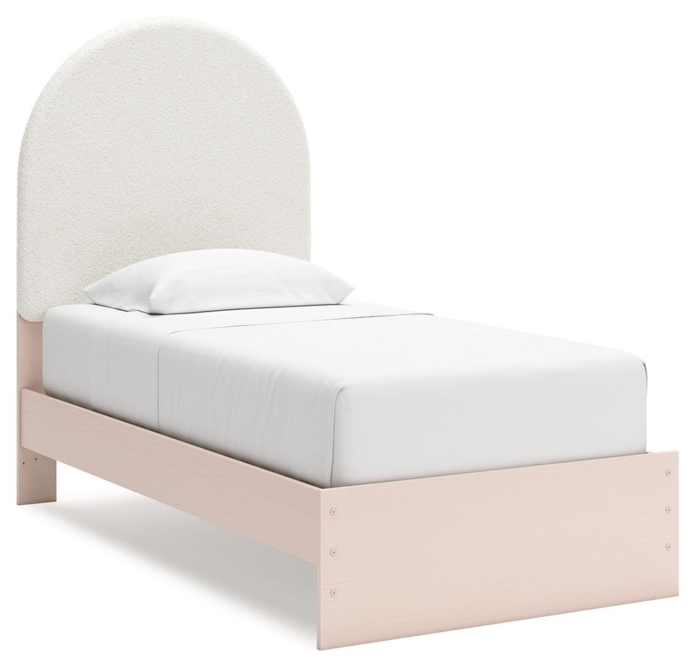 Pretty in pink. This twin upholstered panel bed keeps the spirit of your homeâ€™s modern aesthetic while suiting all your young oneâ€™s needs. Its cozy-cute upholstery and subtle blush finish bring a playful, charming vibe to bedtime. Made for her and sty
