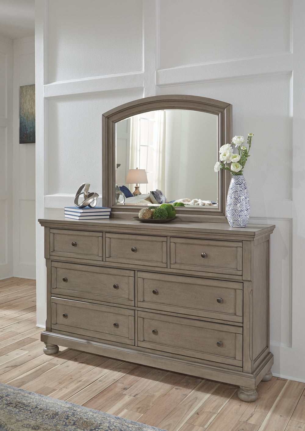 Satisfying your taste for tradition, this dresser and mirror set sports serene sophistication. Forever classic design detailsâ€”inlaid panels, silvertone patina hardware and bun feetâ€”are so easy to love. Seven roomy drawers keep your wardrobe organized 