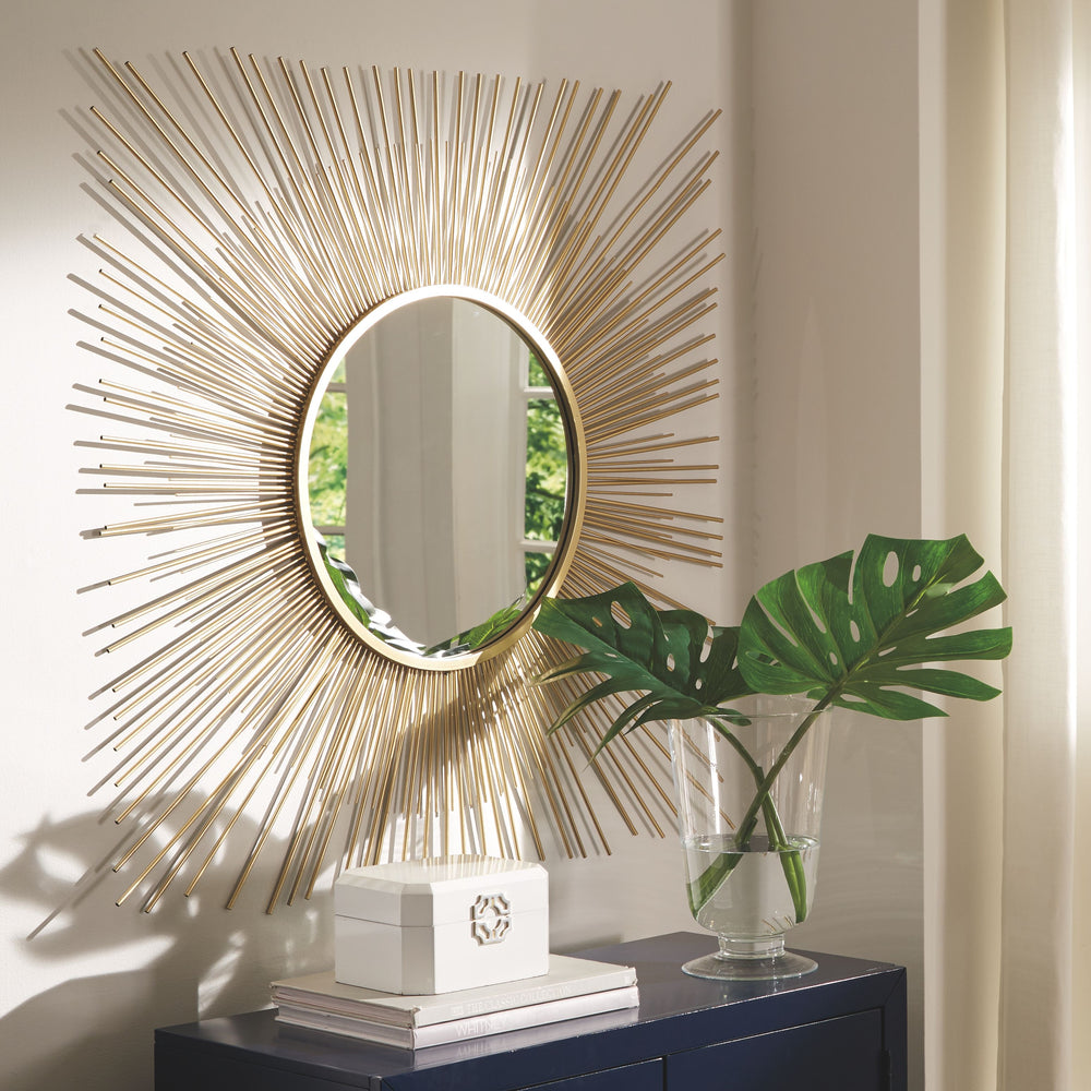 This accent mirror is a contemporary musing. Its breathtaking sunburst design shines in goldtone metal. And the mirrorâ€™s beautifully large scale makes it the center of attention.<br><br><b>Additional Dimensions</b><br><ul><li>Inner mirror: 18.25-"</li><