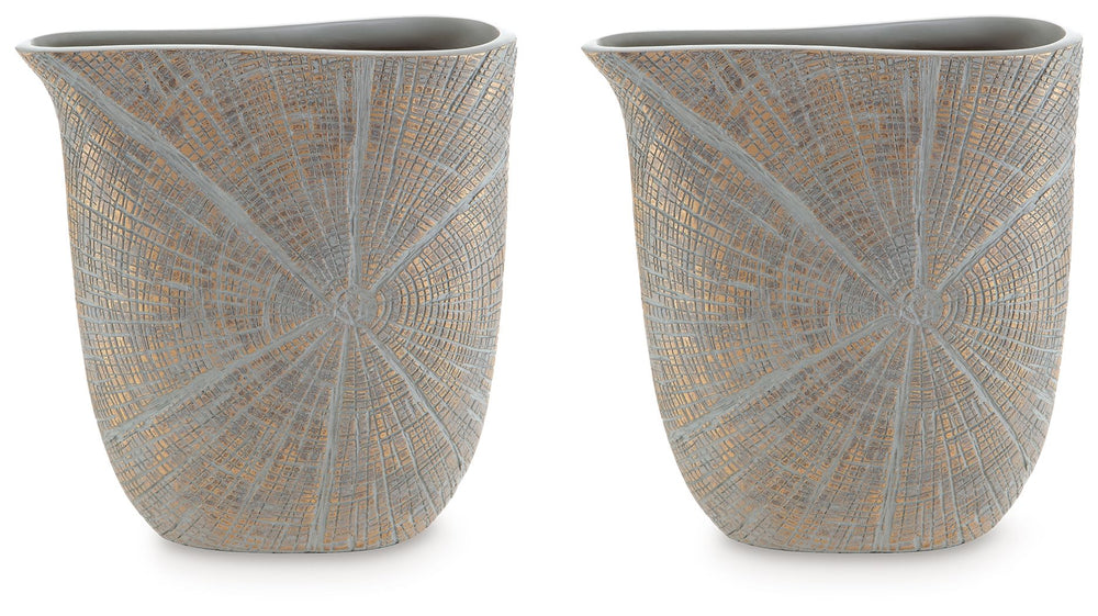 This vase is exquisitely designed with artisanal appeal and a starburst pattern. A unique mix of primitive and modern, it displays a wide mouth to hold your most bountiful bouquets. The intriguing silhouette captures the eye, complementing a room craving 