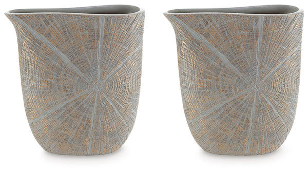 This vase is exquisitely designed with artisanal appeal and a starburst pattern. A unique mix of primitive and modern, it displays a wide mouth to hold your most bountiful bouquets. The intriguing silhouette captures the eye, complementing a room craving 