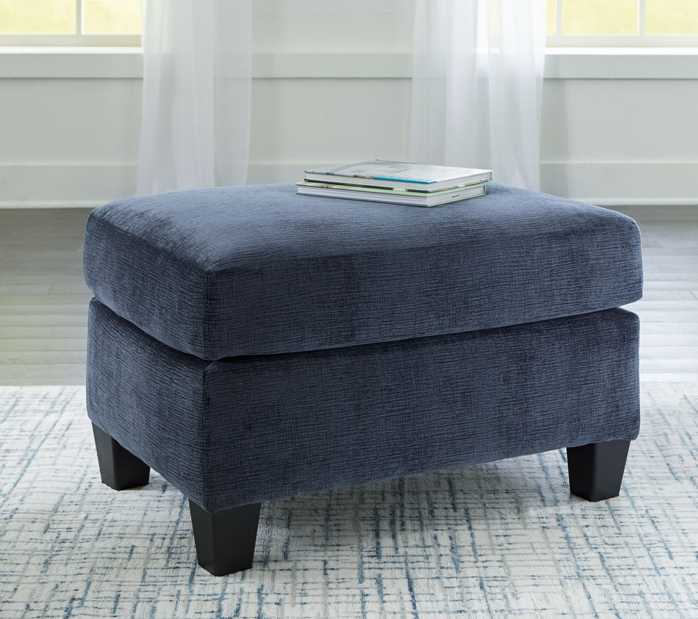 Urban contemporary meets mid century (with a pop of trend-right color) in this ottoman. Supremely soft upholstery, teeming with luster and movement, finesses the piece with just the right touch. Can you think of a better place to throw up your feet in she