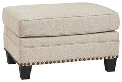 A case of contemporary and classic style influences coming together in a beautiful way, this ottoman in beige brings a fresh perspective to modern farmhouse living. Distinctive elements include nailhead trim and a lovely linen-weave upholstery for an up-t