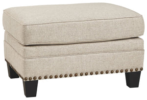 A case of contemporary and classic style influences coming together in a beautiful way, this ottoman in beige brings a fresh perspective to modern farmhouse living. Distinctive elements include nailhead trim and a lovely linen-weave upholstery for an up-t