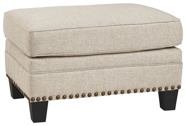 A case of contemporary and classic style influences coming together in a beautiful way, this ottoman in beige brings a fresh perspective to modern farmhouse living. Distinctive elements include nailhead trim and a lovely linen-weave upholstery for an up-t