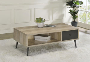  adding a tasteful and practical coffee table. This wood cocktail table fits beautifully in an easy-living family room or living room