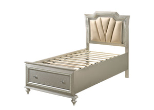 The Kaitlyn bed provides a commanding presence in any master bedroom. This contemporary storage bed in champagne finish features a diagonal channeled tufted padded headboard and a low-profile footboard with storage drawers. Expertly crafted with a glam lo