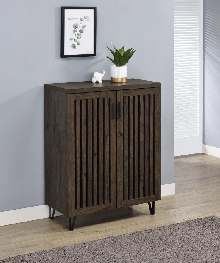 Transform your foyer or hallway with this versatile shoe cabinet, designed to keep your footwear organized and out of sight while complementing a variety of interior styles. Behind its distinctive vertical-slatted doors, multiple adjustable shelves provid