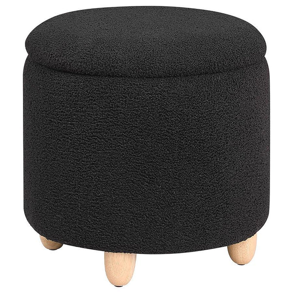 Nestled atop subtle, natural brown rounded wood feet, this round storage ottoman is a stylish statement of comfort and practicality. Upholstered in a soft faux sheepskin, it beckons with tactile appeal, inviting a moment of relaxation. The removable top u