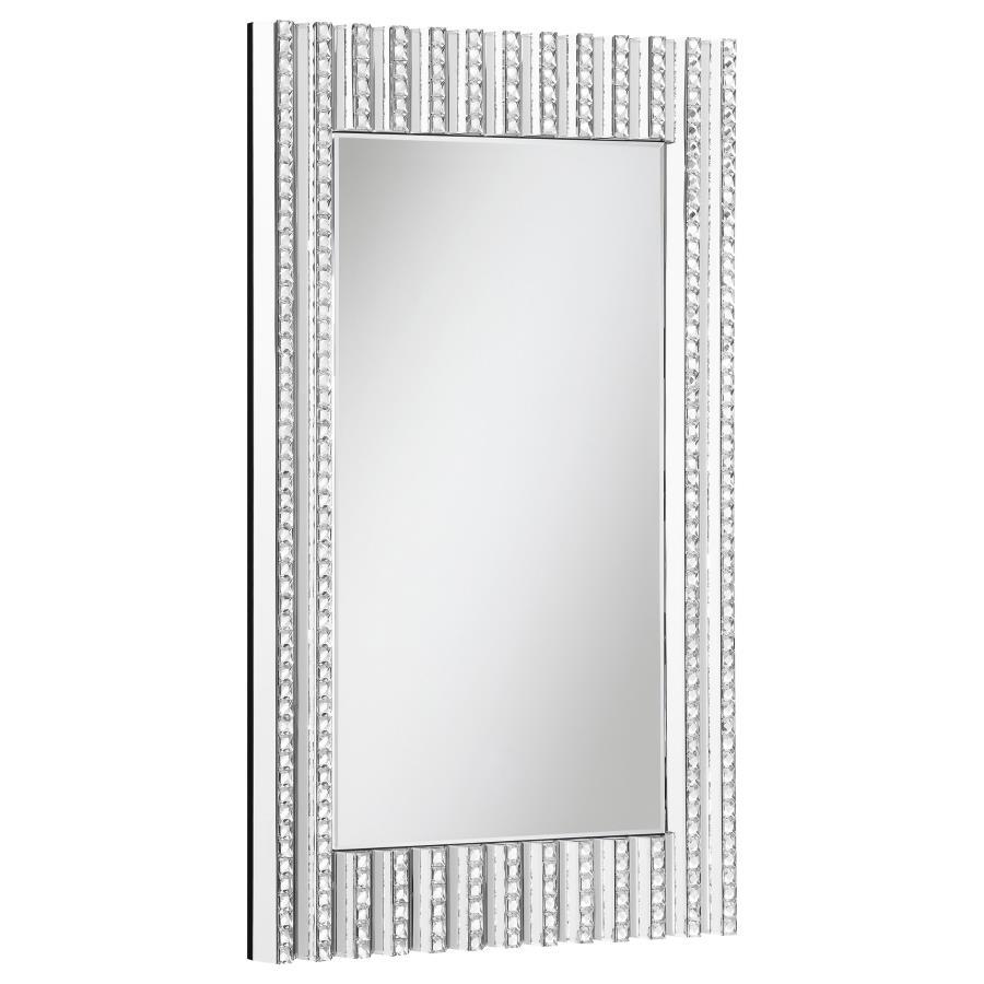 Mount this stunning glam mirror on an entryway foyer wall or above a bathroom vanity for a bit of sparkle. With a long rectangular shape and dimensional frame, this contemporary style mirror is sure to catch the eye. Vertical lines fuse together, half of 