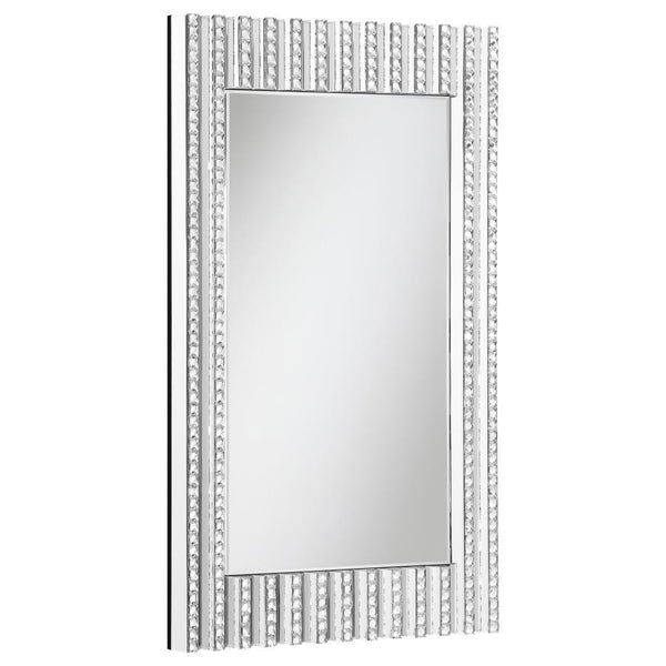 Mount this stunning glam mirror on an entryway foyer wall or above a bathroom vanity for a bit of sparkle. With a long rectangular shape and dimensional frame, this contemporary style mirror is sure to catch the eye. Vertical lines fuse together, half of 