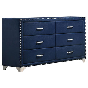 Give outdated sleeping spaces a facelift with this eye-popping and elegant dresser. Entirely upholstered in velvet, this dresser is a conversation starter. It is equipped with six spacious drawers to store your bedside items. Nail head trim makes a specta