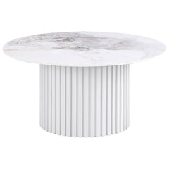 This round coffee table showcases a luxurious sintered stone top with elegant veining, offering durability and style for modern living spaces. The sturdy metal base features a fluted design and a sleek white powder-coated finish, providing a clean and con