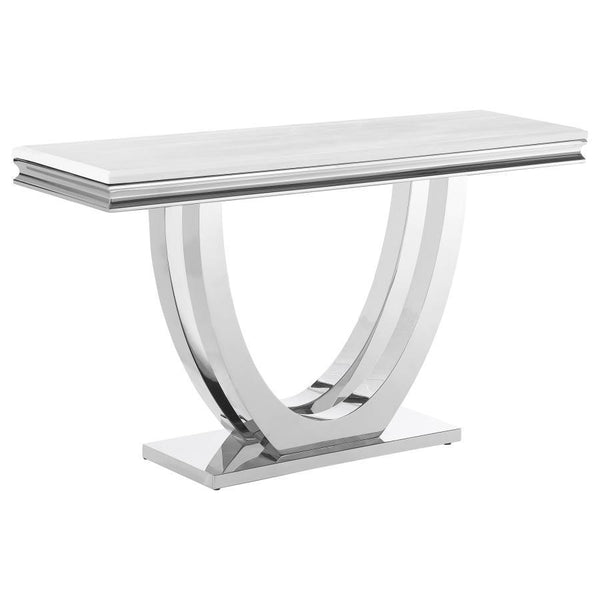 This modern console table showcases luxury and elegance with a sintered stone top that features a marble-like appearance and beveled edges. The sweeping demilune pedestal base, crafted from polished stainless steel, adds sculptural beauty and durability. 