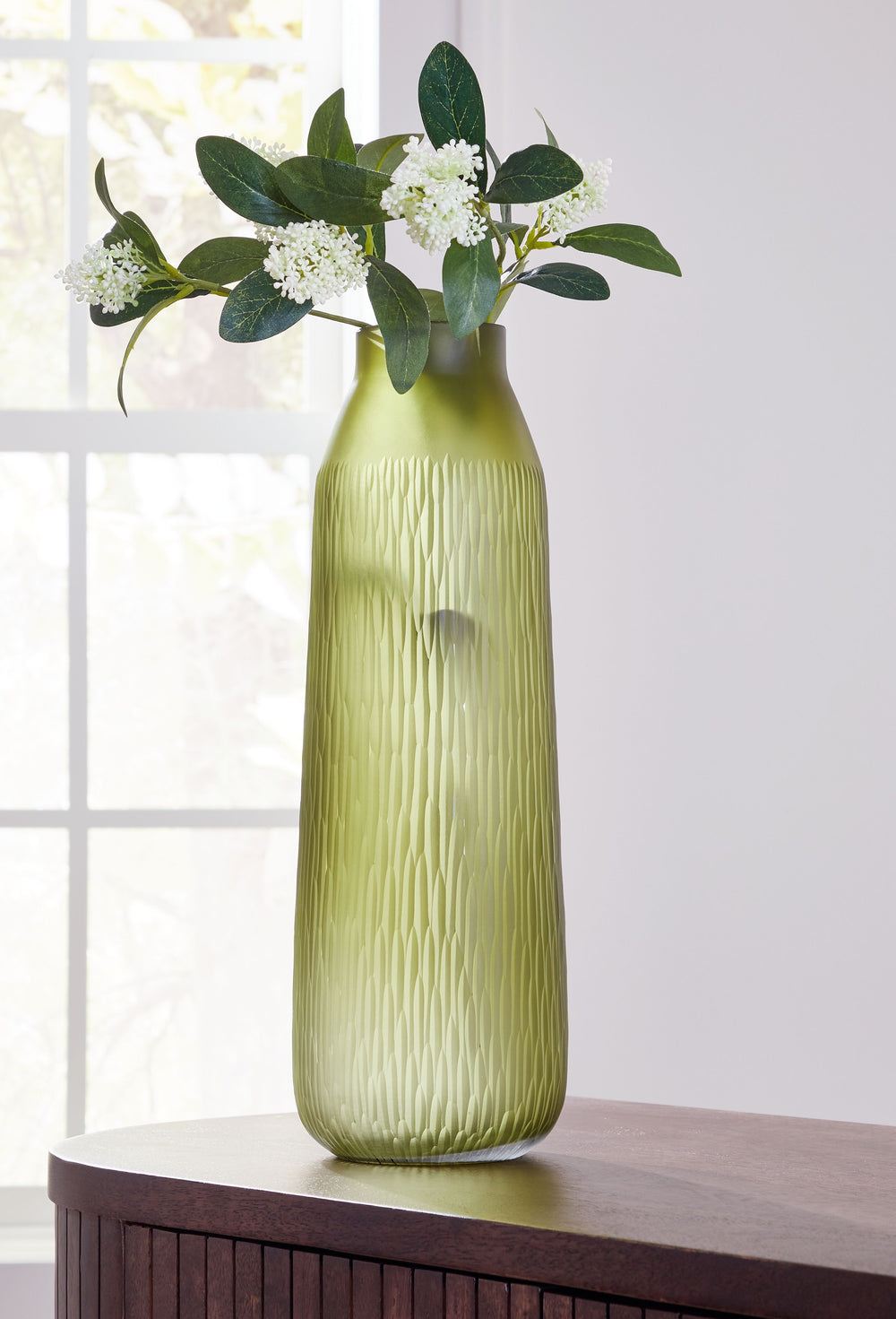 Creating a contemporary haven is all in the details. With this vase, you can keep your elevated aesthetic consistent from indoors to out. Its luxe green color brings a touch of brightness to your tabletops and shelves. Take on-trend design one step furthe