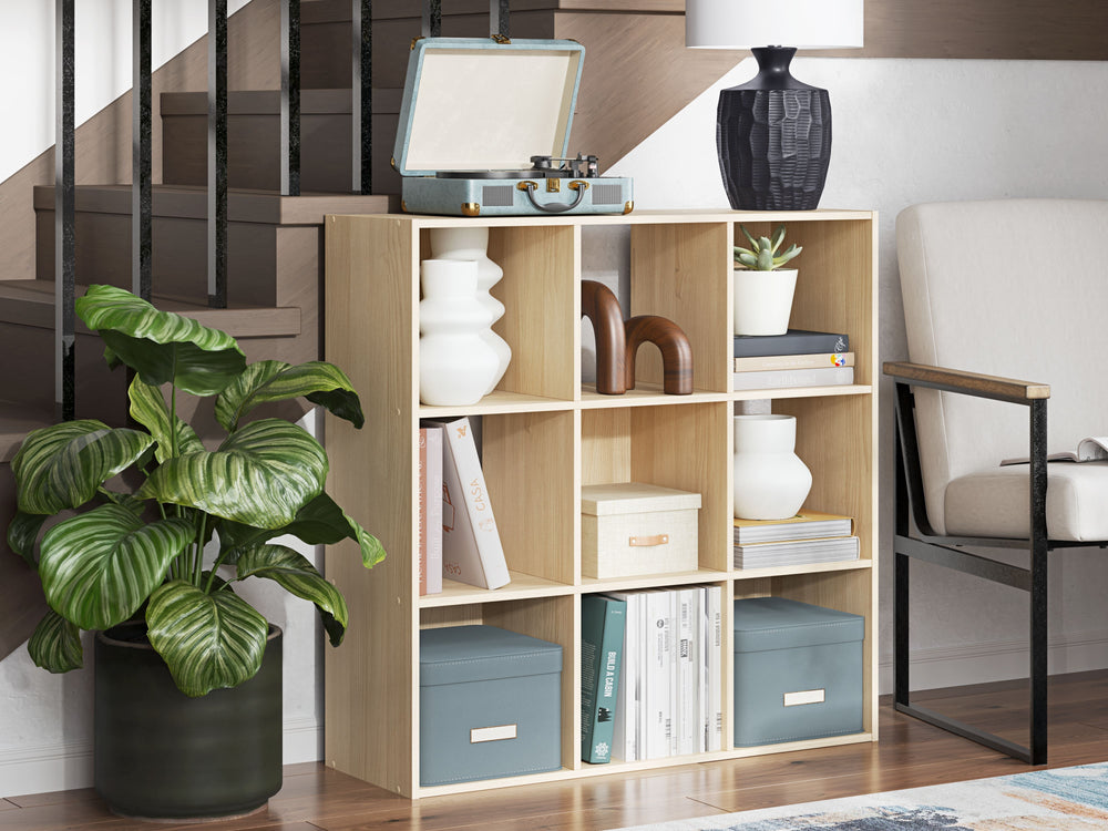 Keep clutter out from underfoot with this nine-cube organizer. The natural finish over replicated ash wood grain is warm and inviting, all while keeping your toys, knickknacks and other items stored away. The perfect marriage of style and function, this o