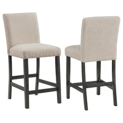 Elevate your dining experience with this chic counter height chair, a blend of simplicity and texture. Wrapped in the luxurious touch of boucle fabric, the chair offers a tactile feast, inviting guests to savor every second seated. Its silhouette stands t