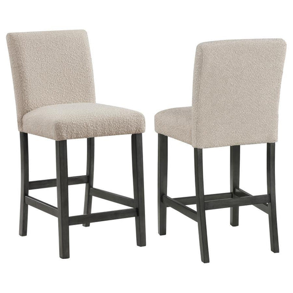Elevate your dining experience with this chic counter height chair, a blend of simplicity and texture. Wrapped in the luxurious touch of boucle fabric, the chair offers a tactile feast, inviting guests to savor every second seated. Its silhouette stands t