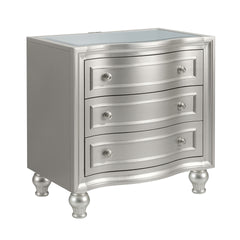 Introducing the Reflection Nightstand in Silver, expertly crafted from solid Pine and high-quality manufactured wood to ensure enduring strength and durability. Its glamorous matte silver finish exudes sophistication, accentuating the mirrored top and sil