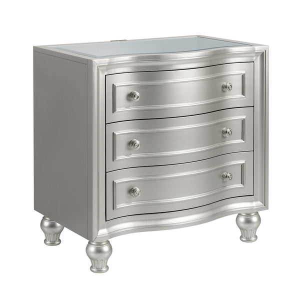 Introducing the Reflection Nightstand in Silver, expertly crafted from solid Pine and high-quality manufactured wood to ensure enduring strength and durability. Its glamorous matte silver finish exudes sophistication, accentuating the mirrored top and sil