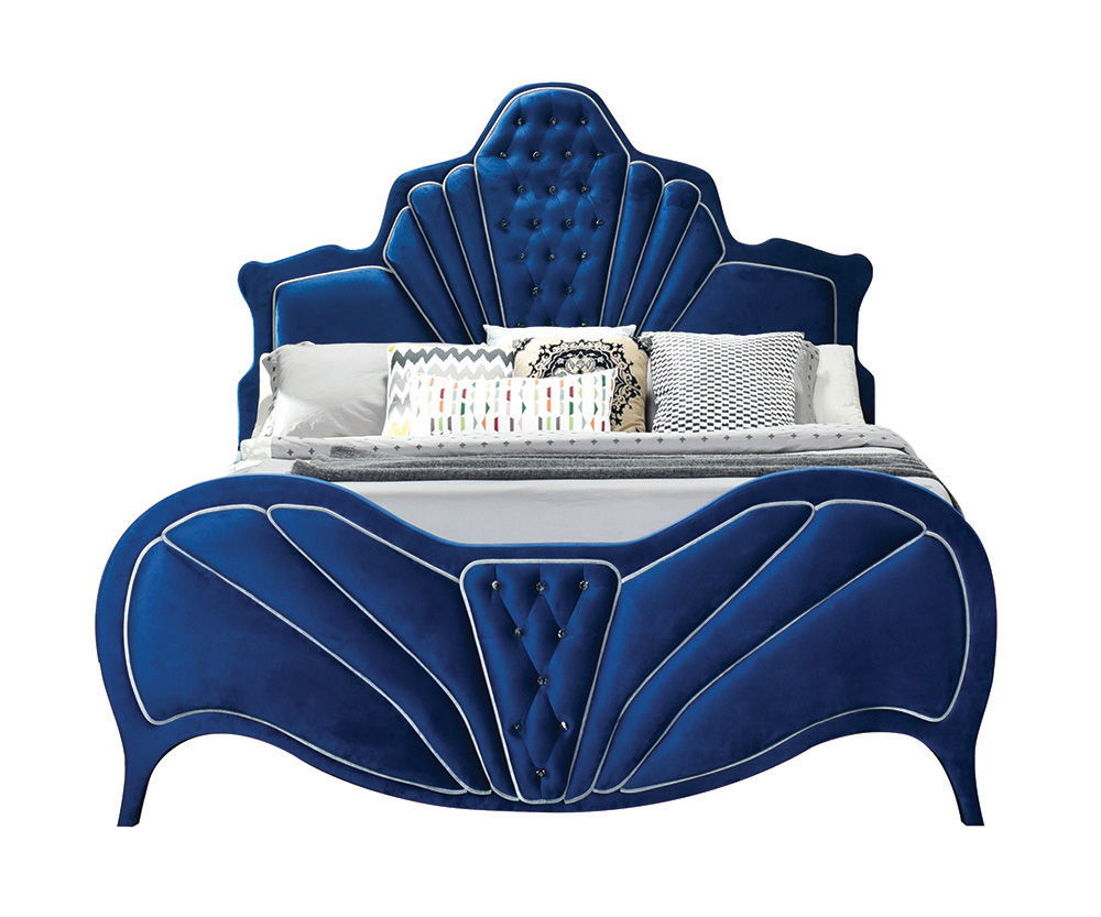 This fully padded blue velvet bedroom set is visually stunning, including beautiful channel tufting and contrasting welted trim arched head and footboards. Upholstered casegoods maintain the ambiance of this chic bedroom. Incorporating padded fronts, tape