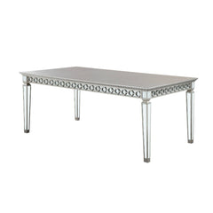 Let the Varian dining collection reflect your brilliant style! This chic set features a rectangular table accented with a beveled mirror trim in a geometric design. The matching chairs are upholstered in a lustrous blue fabric and supported by elegantly t