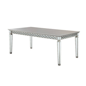 Let the Varian dining collection reflect your brilliant style! This chic set features a rectangular table accented with a beveled mirror trim in a geometric design. The matching chairs are upholstered in a lustrous blue fabric and supported by elegantly t